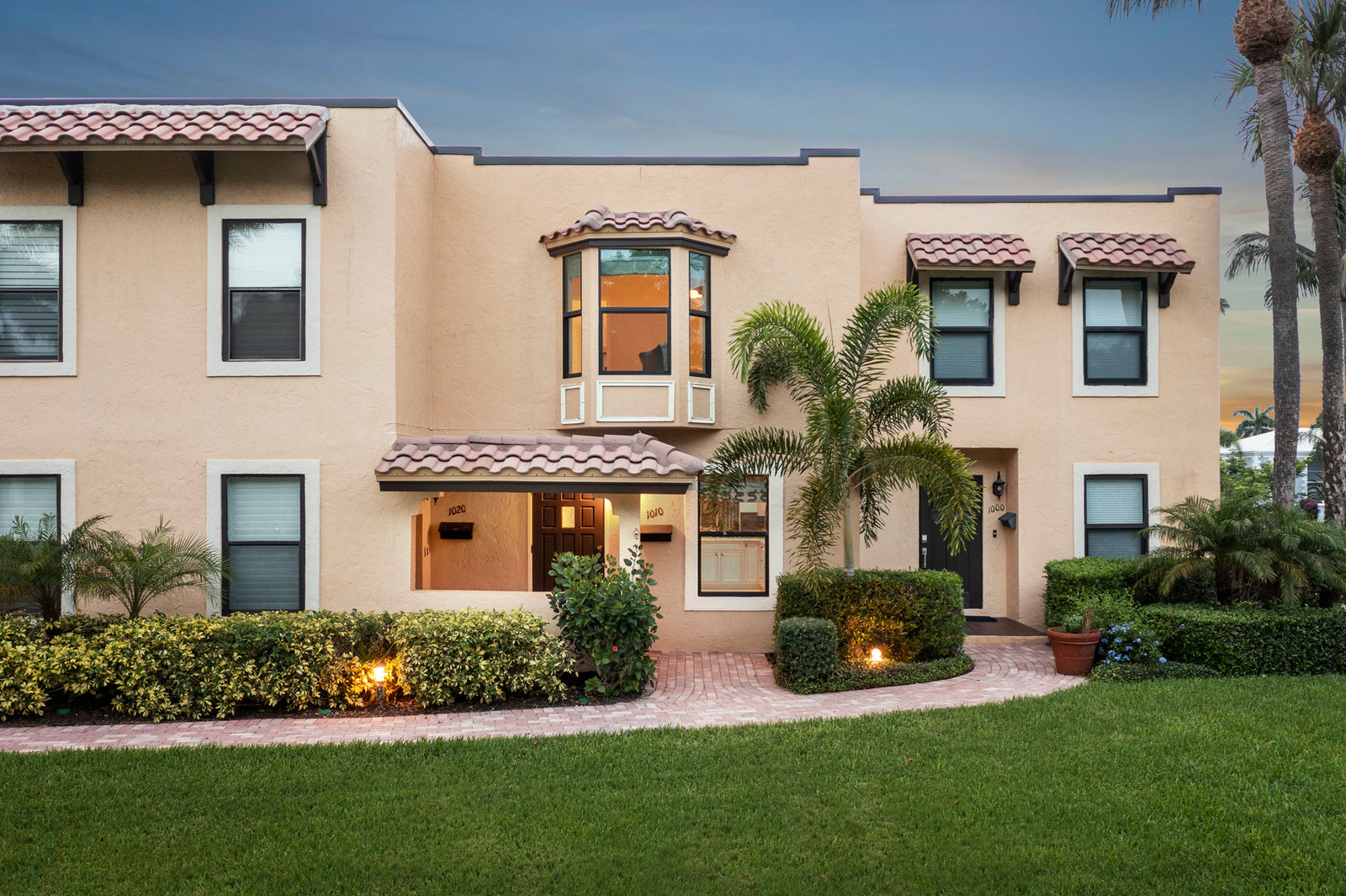 Warmly illuminated entrance of a Southwest Florida home